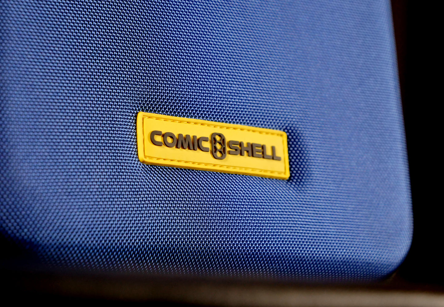 Close up of Black and Yellow Comic Shell logo