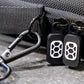 Black shoulder strap and D-Ring sewn into Comic Shell comic travel case, with dark metal hardware. Two black and white Comic Shell logo zipper pulls 