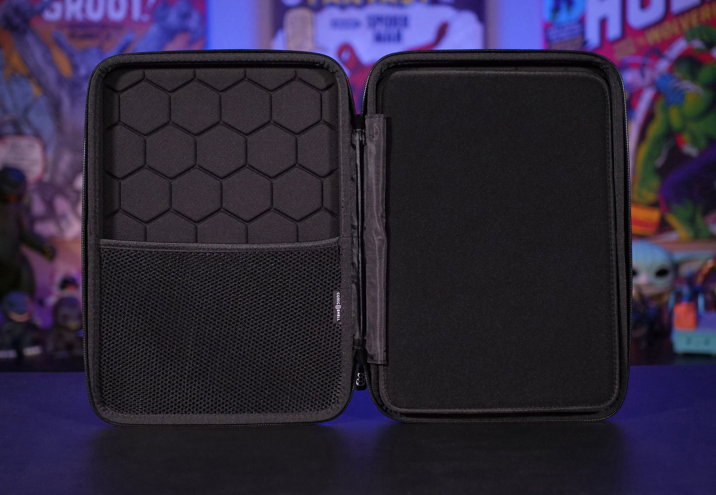 Open view of left half of Comic Shell travel case with a middle divider panel for protection